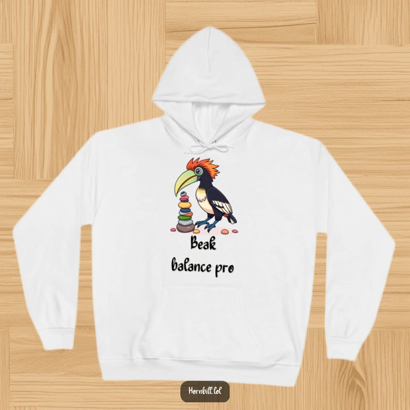 Funny hoodie depicting a determined hornbill bird attempting to master the art of balancing a colorful tower of pebbles on its beak.