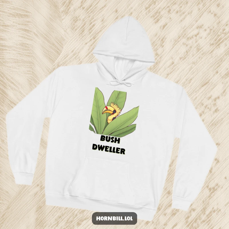 Funny Hoodie: A hornbill's head peeking out from behind a large, dense leafy bush, exuding curiosity and natural charm.