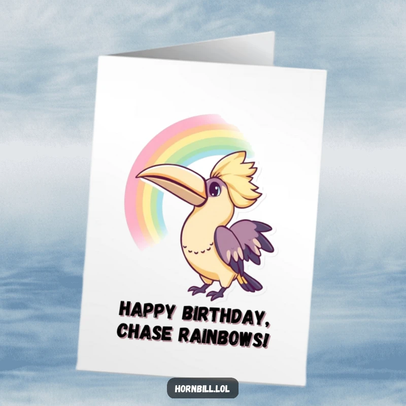 Free Printable Birthday Card: A cute kawaii hornbill tilts its head, looking up with bright, curious eyes at a vibrant rainbow.