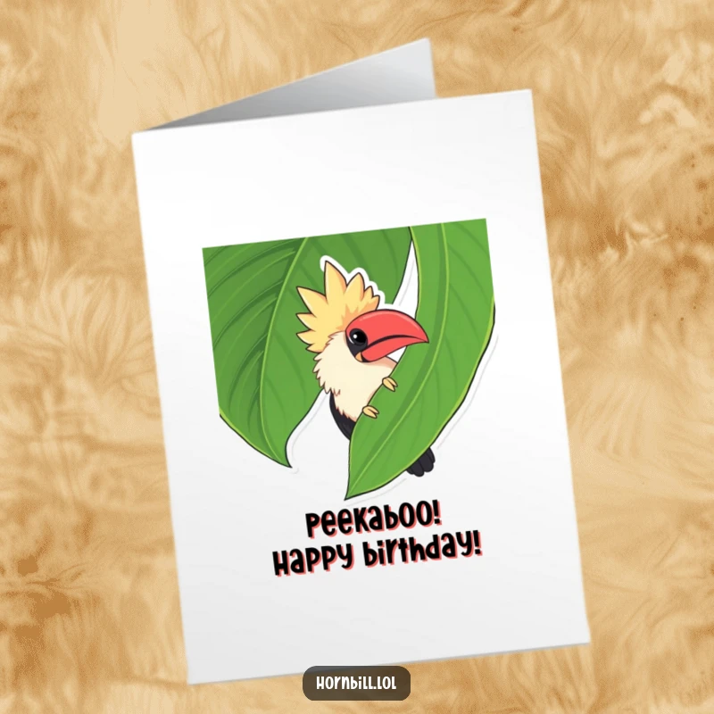 Funny Free Printable Birthday Card: Chubby hornbill playfully peeking from behind a giant green leaf, ready to surprise.